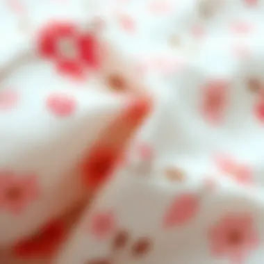 Close-up of soft pink floral cotton fabric texture