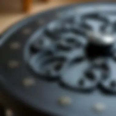 Close-up of the intricate design of a black iron round coffee table
