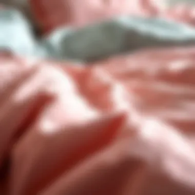 Close-up view of the fabric texture of a pink and grey comforter
