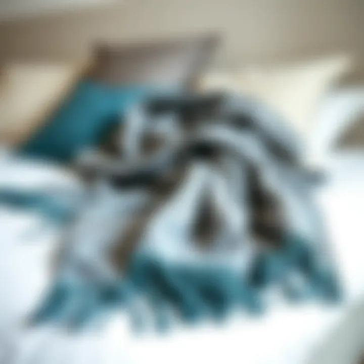 Combination of gray and teal throw blanket on a cozy bed